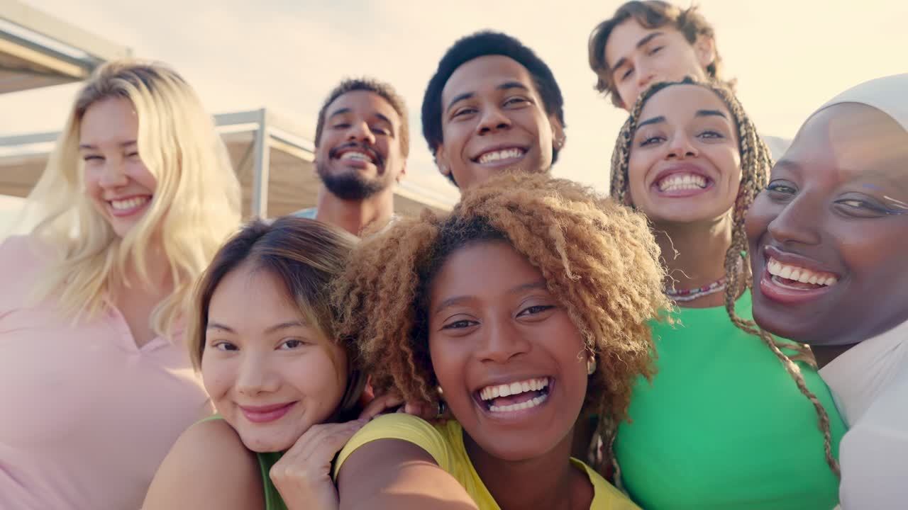 Excited multi-ethnic friends taking selfie outdoors during sunset