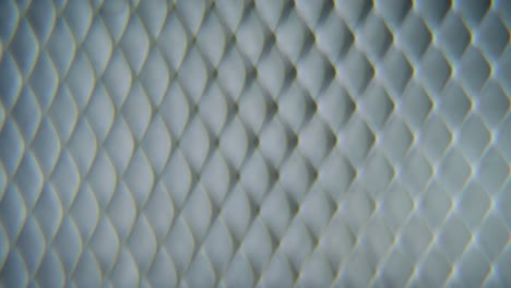 a dreamy macro shot of a metal grid, steel pattern, iron industrial texture, aluminum material, super slow motion, full hd 120 fps, smooth crane zoom out movement, blurry depth of field