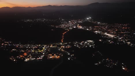 Aerial-footage-capturing-vibrant-sunsets-above-Huatulco's-bays,-Mexico