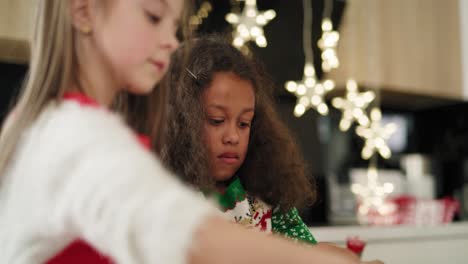 Handheld-video-shows-of-two-little-girls-decorating-Christmas-cookies