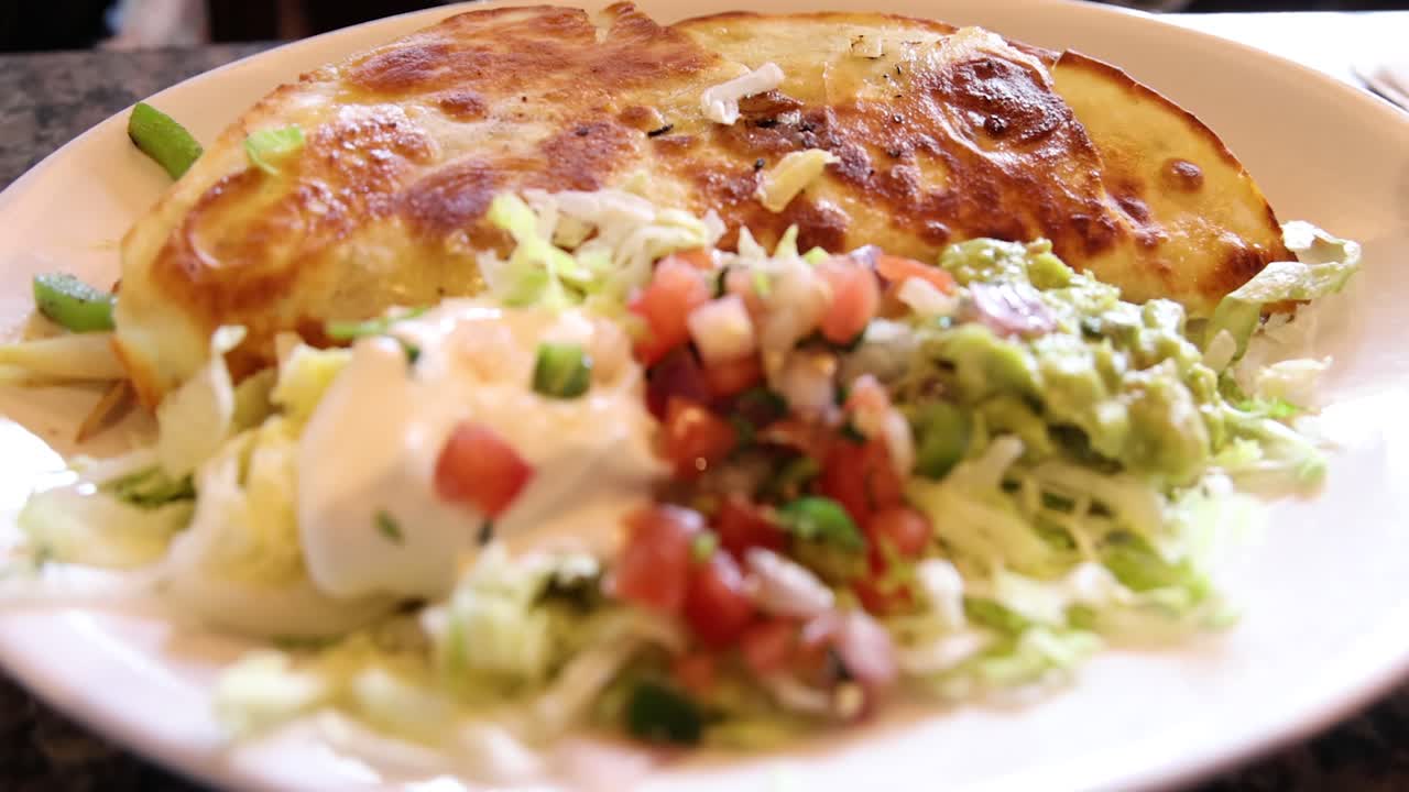 Mexican food on a plate in a restaurant.