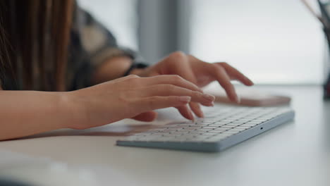 copywriter typing keyboard text at table closeup. programmer writing pc code