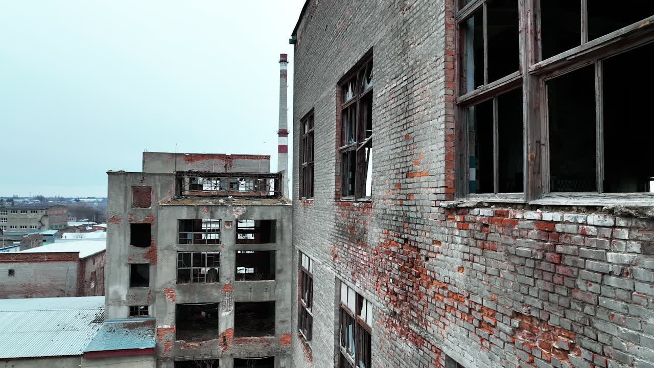 Ruined and abandoned territory of industrial plant. Buildings of an old plant destroyed with time and nature.