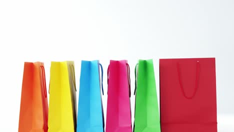 multicolored shopping bags on white background