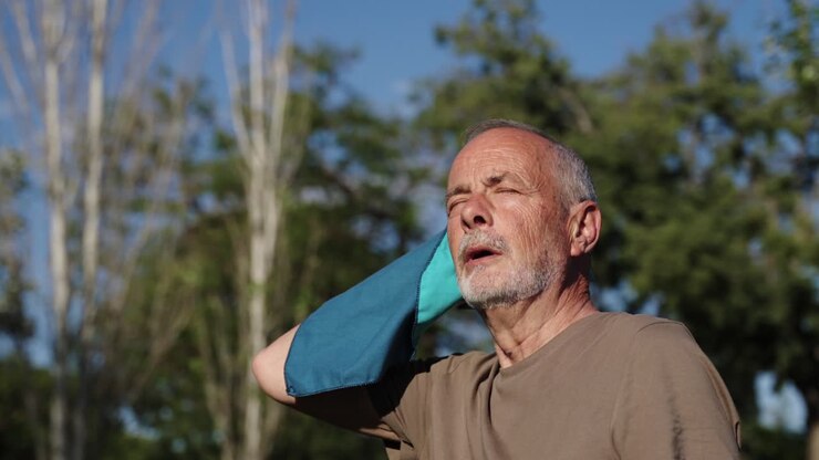 Man wiping sweat with a towel