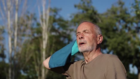 man wiping sweat with a towel