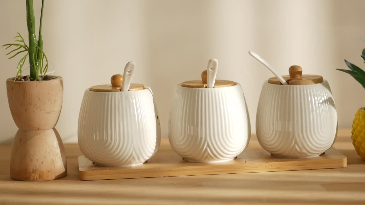 Elegant White Ceramic Spice Jars on a Wooden Tray