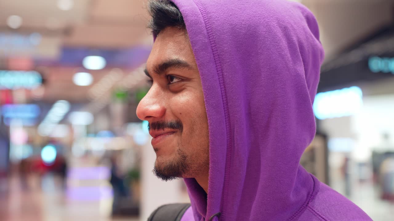 cerrar el retrato de un joven emocionado sonriendo en el centro comercial mall