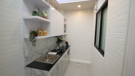 white kitchen decrorated with marble and mosaic tiles