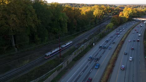 commuter train railroad rail beside interstate highway