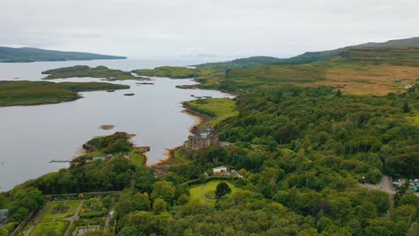 Dunvegan-Castle-on-Isle-of-Skye-surrounded-by-woodland-in-overcast-weather,-aerial-view