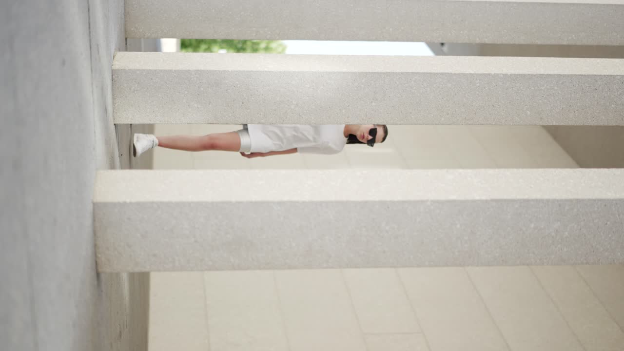 Vertical: modern high-fashion urban video shoot, woman wearing trendy clothing