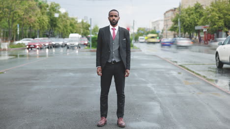 businessman in a suit on a rainy city street