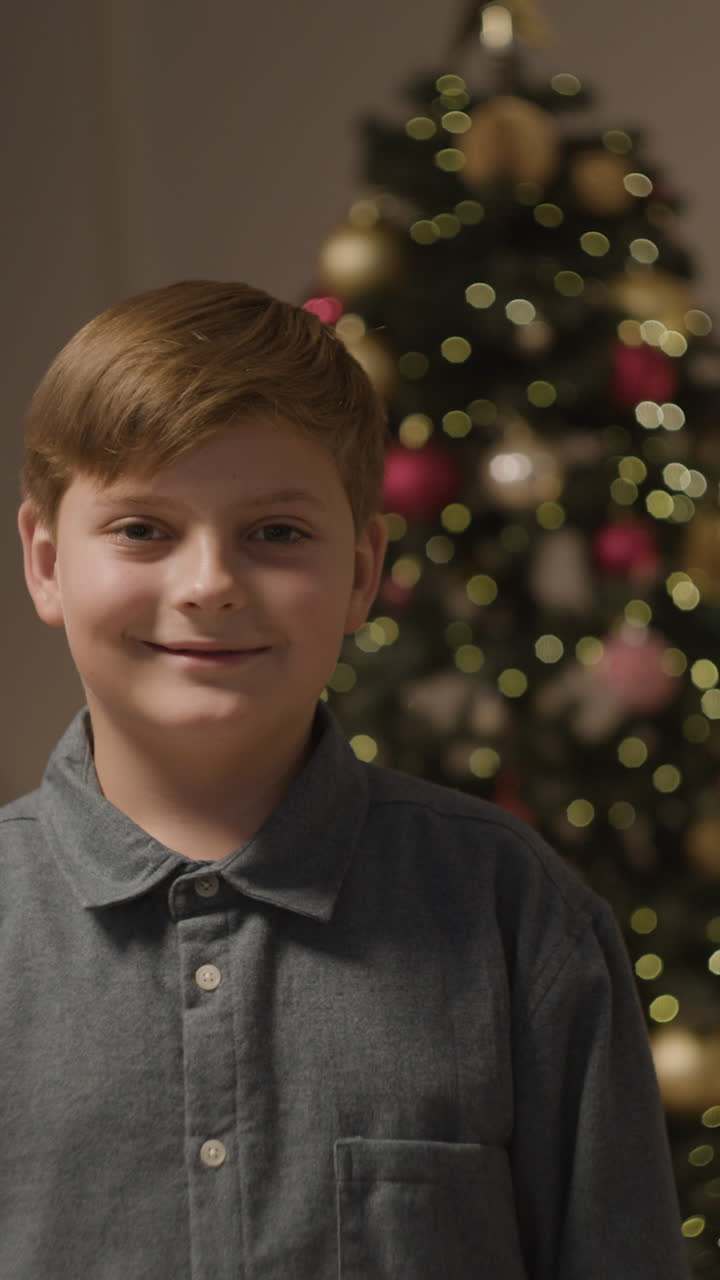 Boy in front of Christmas tree