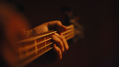 close up of fingers playing bass guitar-2