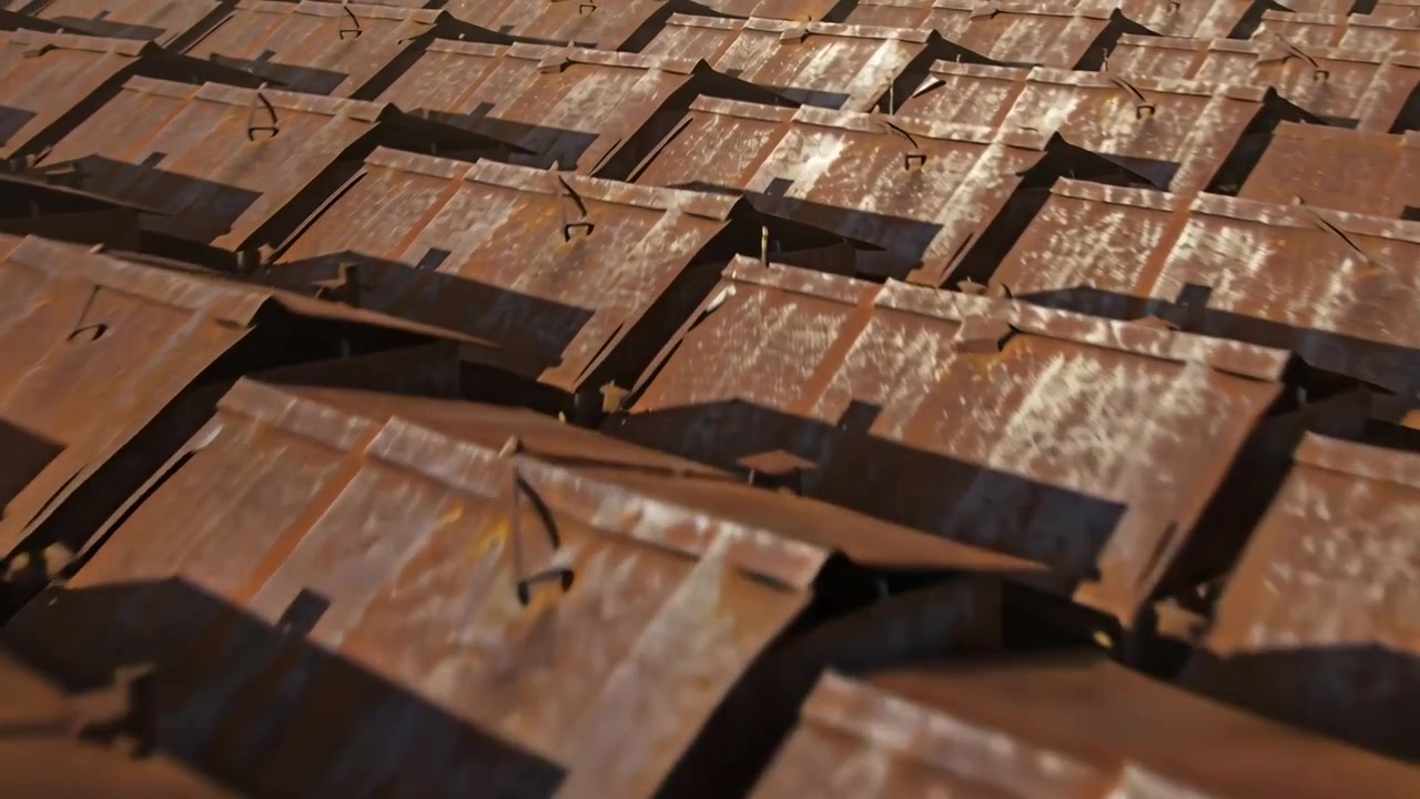 Panning camera shifting forward over pitched roof, revealing rusted tiles and metal fasteners