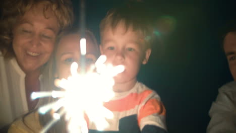 parents child and sparkler at night