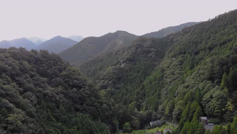 drone shot of peaceful mountainside with trees and houses in between