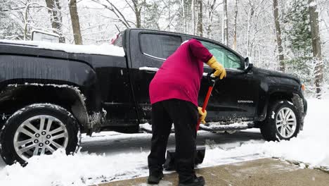 Close-and-low-angle-of-a-man-shoveling-a-layer-of-fresh-snow