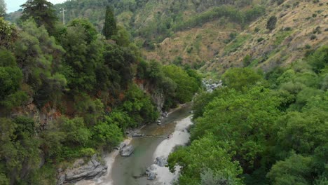 4k aerial dolly in: drone flying above alcantara gorges, an impressive channel of lava columns eroded naturally into ravines, canyons and caves