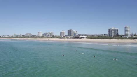 swimming on maroochydore beach, sunshine coast, queensland, australia, aerial pullback shot