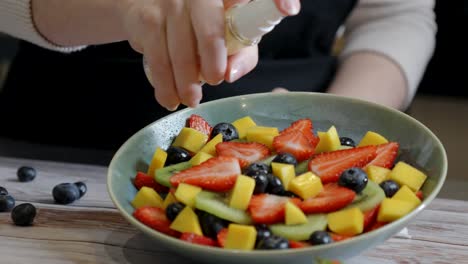 slow motion of water being sprayed onto a fruit salad for presentation and photos