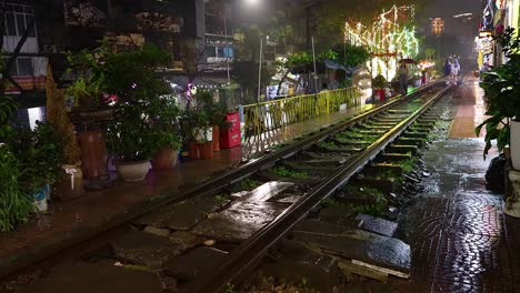 rainy night scene with illuminated railway