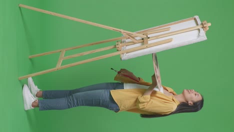 woman painting on an easel