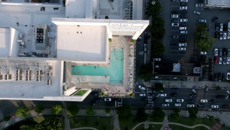 Overhead view of rooftop pool in Atlanta, bordered by city streets and a parking lot