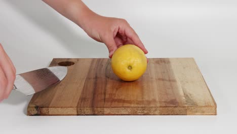 sequential steps of cutting a lemon into halves