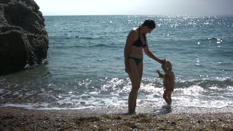 mother and child playing on the beach