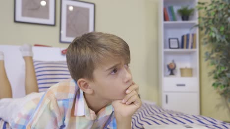 niño pensativo en su cama. estudio.