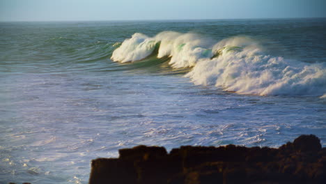 huge ocean wave rolling in slow motion. scenic foaming sea swelling on sunny day