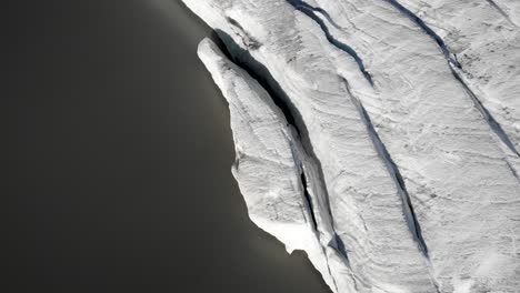 Paso-Elevado-Aéreo-Con-Una-Vista-Aérea-Del-Hielo-Y-Las-Grietas-En-El-Lago-Glacial-Junto-Al-Glaciar-Claridenfirn-En-Uri,-Suiza