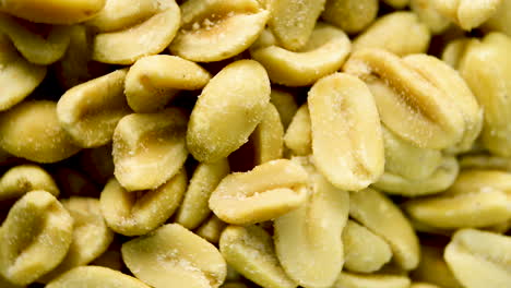 close up of salted peanuts rotating