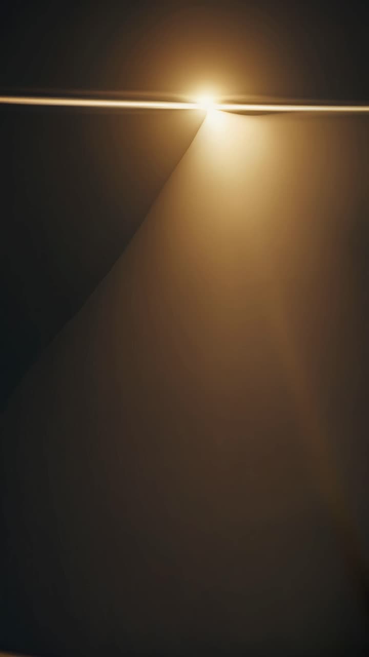 Abstract video concept with warm light beams creating geometric patterns