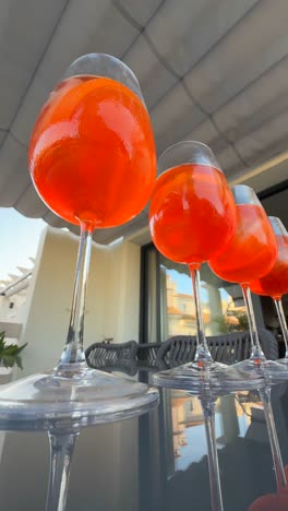 two aperol spritz cocktails on a terrace
