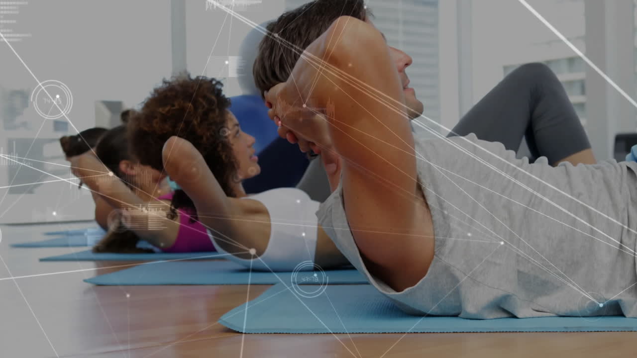 Fitness participants performing crunches on blue mats featuring network lines and biometric charts