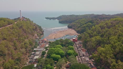 Birds-eye-view-establishing-shot-of-beach-coast-at-Baron-Beach,-Indonesia-at-day