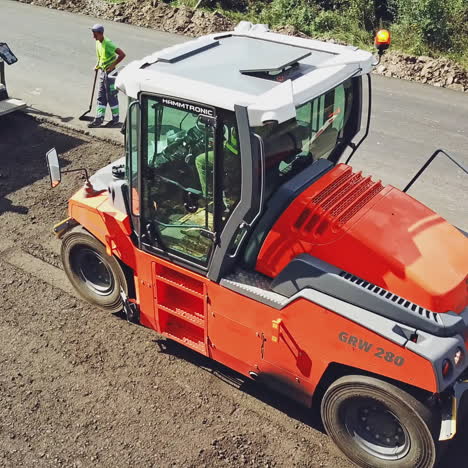 large road-roller paving a road. road construction. aerial view.
