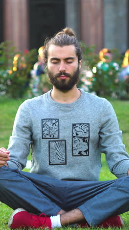 man meditating in a park