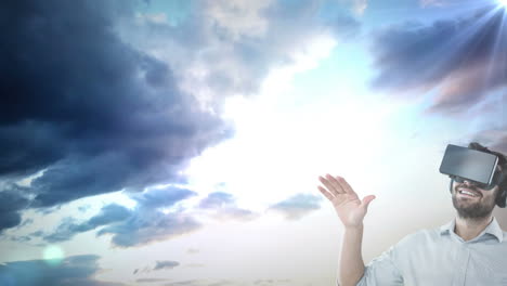 caucasian man wearing vr headset against spot of light and clouds in the sky