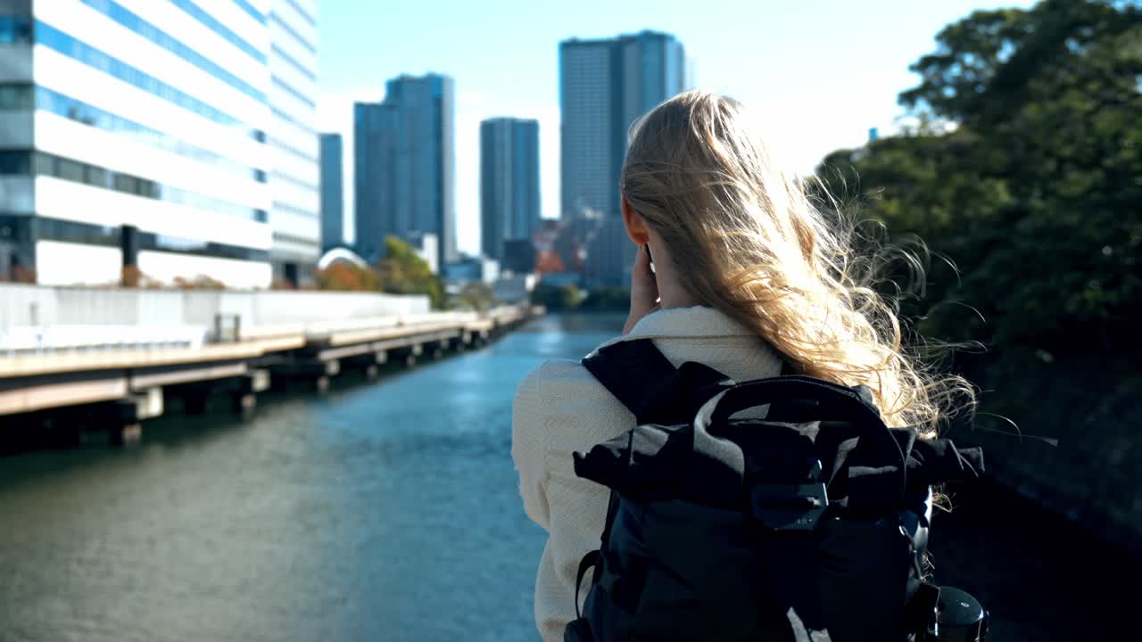 A serene shot of a photographer immersed in capturing the beauty of Hamarikyu Gardens in Tokyo.