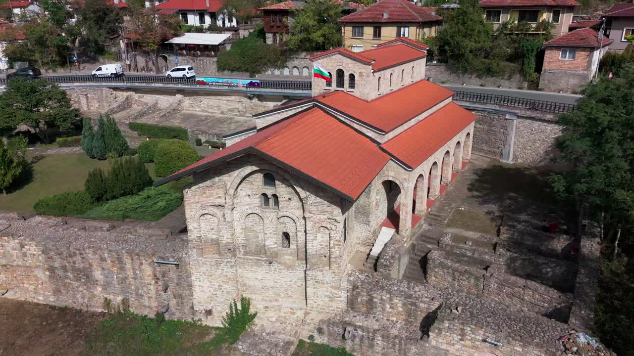 Drone circling Holy Forty Martyrs Church from right to left, showcasing medieval architecture and roof tiles.