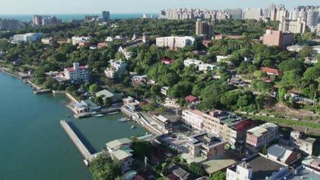 coastal cityscape with lush greenery and urban buildings, clear skies in tamsui, taipei