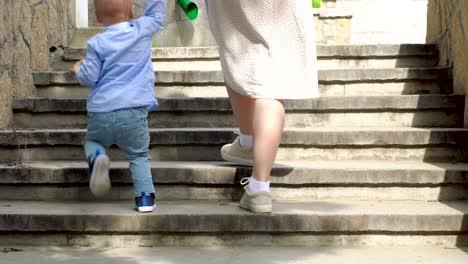 mother and child walking up stone stairs