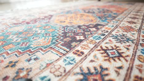 hand touching a colorful patterned rug