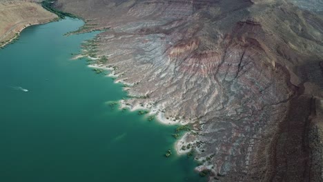 Aerial-View-of-Water-Reservoir-and-Layered-Sandstone-Cliffs-in-Urah-USA-Landscape,-Quail-Creek-State-Park