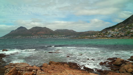 Noon-Fish-Hoek-Simon's-Town-Muizenberg-stunning-windy-sea-coastline-reef-ocean-small-fishing-town-on-coast-Cape-Town-South-Africa-Boulder-Beach-Penguin-Whales-Naval-sea-sailboat-pan-left