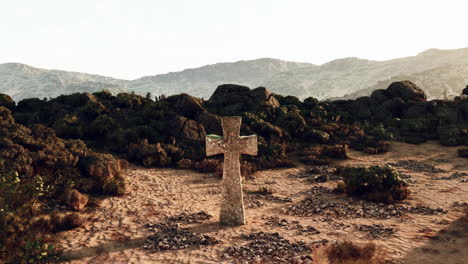 stone cross in a desert landscape